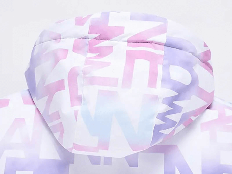 Close-up of a stylish female letter printed ski jacket hood with pastel letters, perfect for skiers wanting comfort and flair.